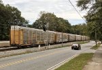 CSX TTGX 979543 at the tail end of a line of autoracks